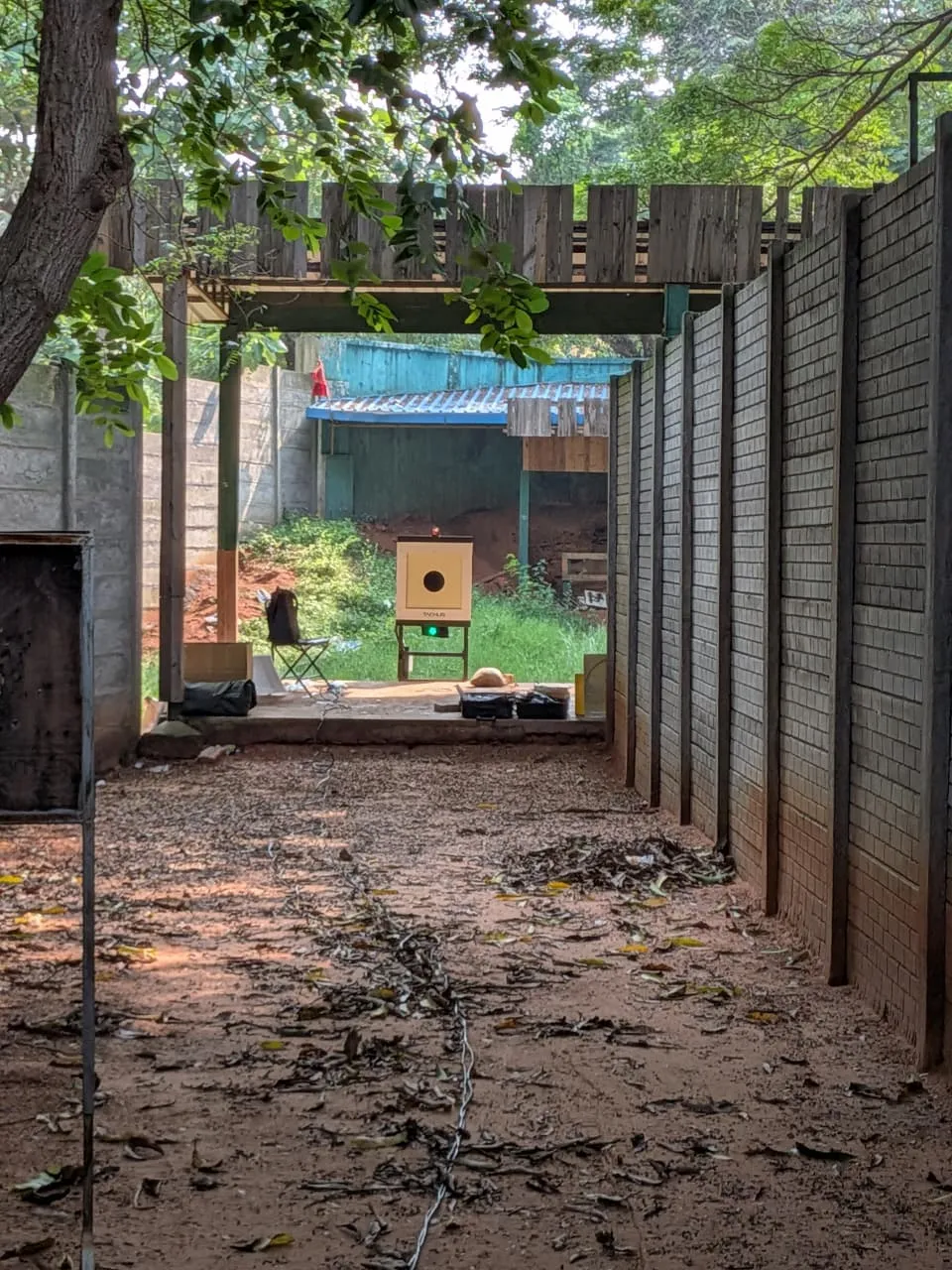Tachus 25 electronic target unit at the end of an outdoor walled shooting lane