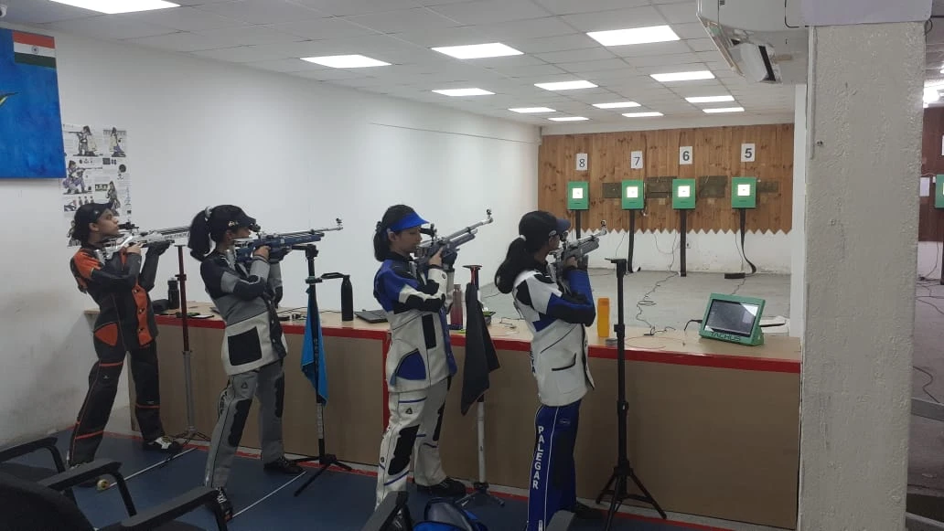 Four athletes training on Tachus electronic targets at an indoor academy range