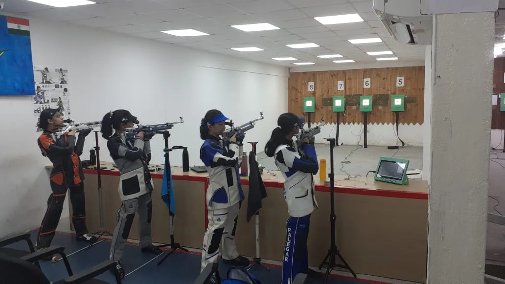 Four athletes training on Tachus electronic targets at an indoor academy range