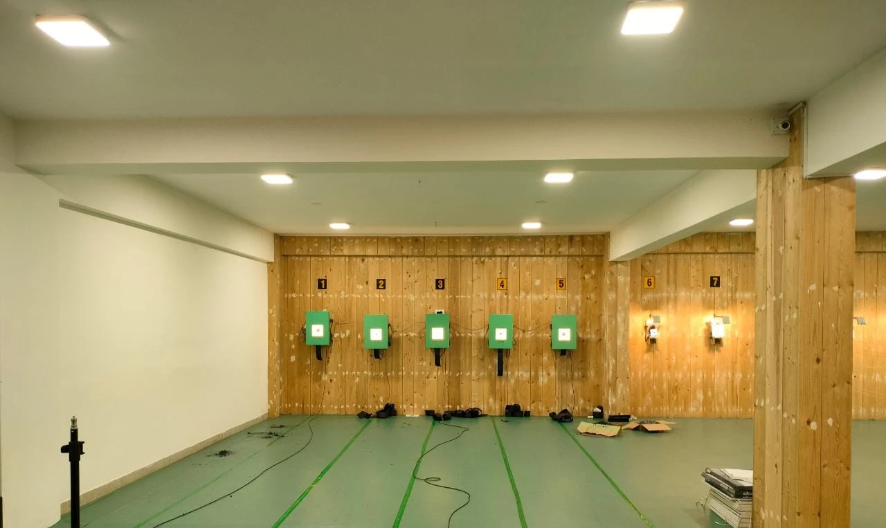 Empty indoor range with Tachus electronic targets installed along the back wall