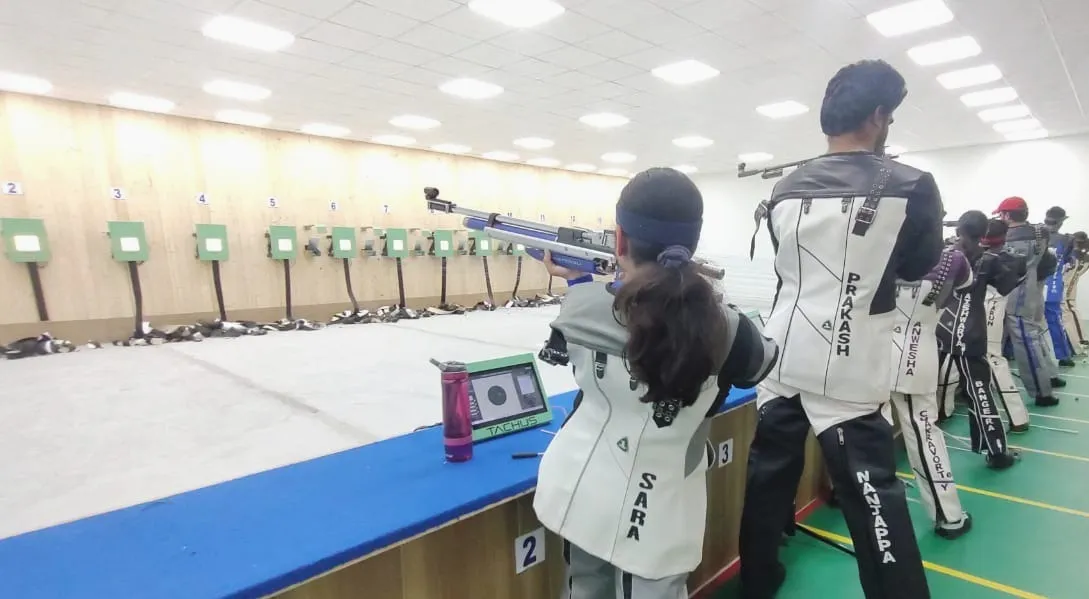 Athletes training on a Tachus electronic target range with multiple lanes