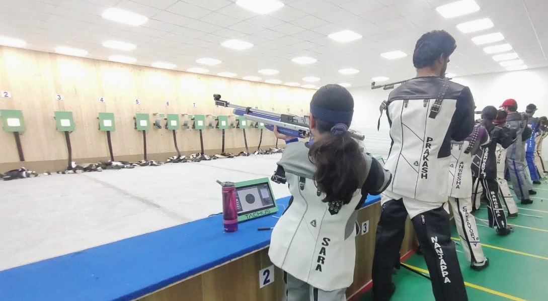Athletes training on a Tachus electronic target range with multiple lanes