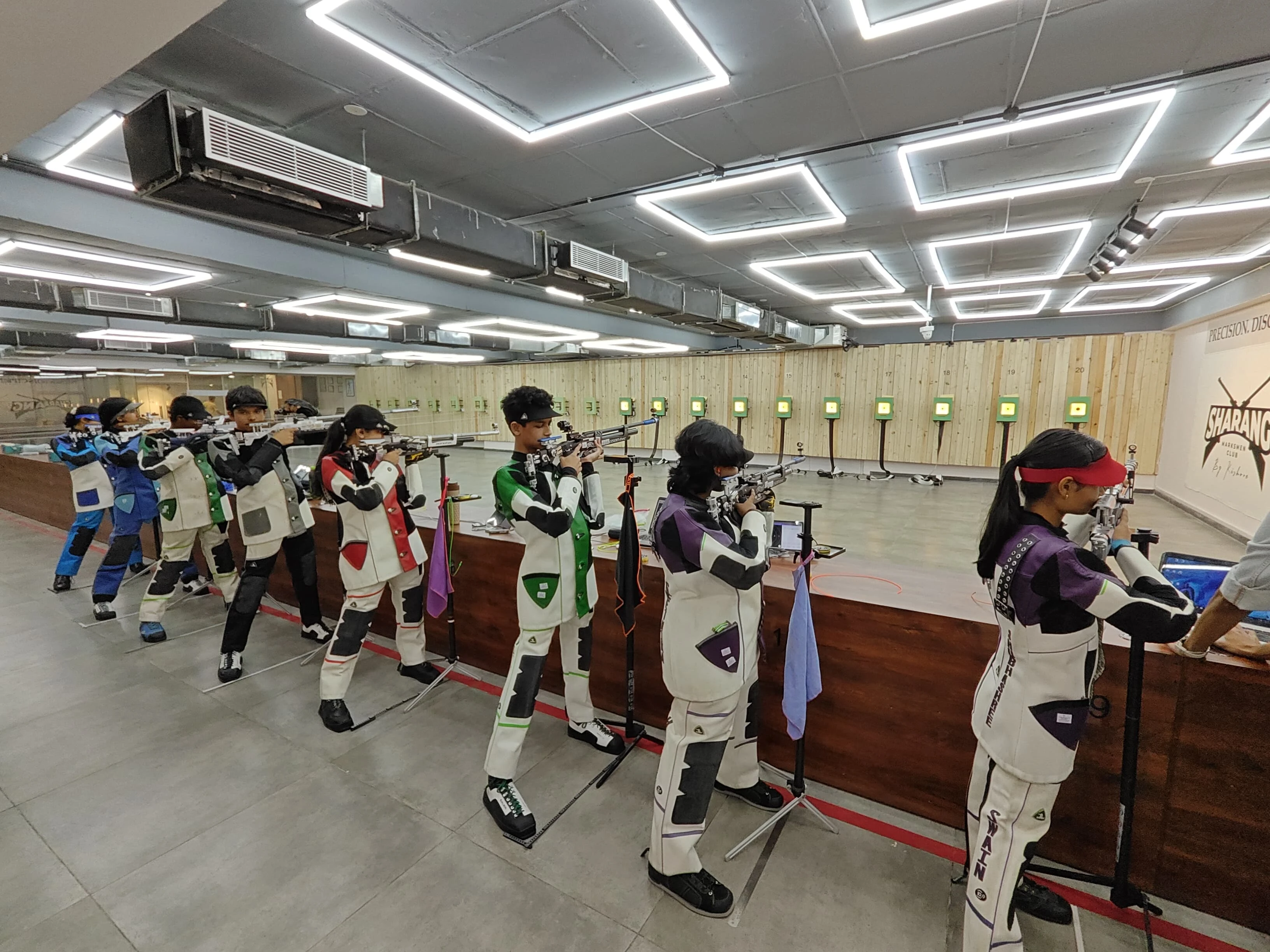 Junior athletes training with Tachus electronic targets in an indoor shooting range