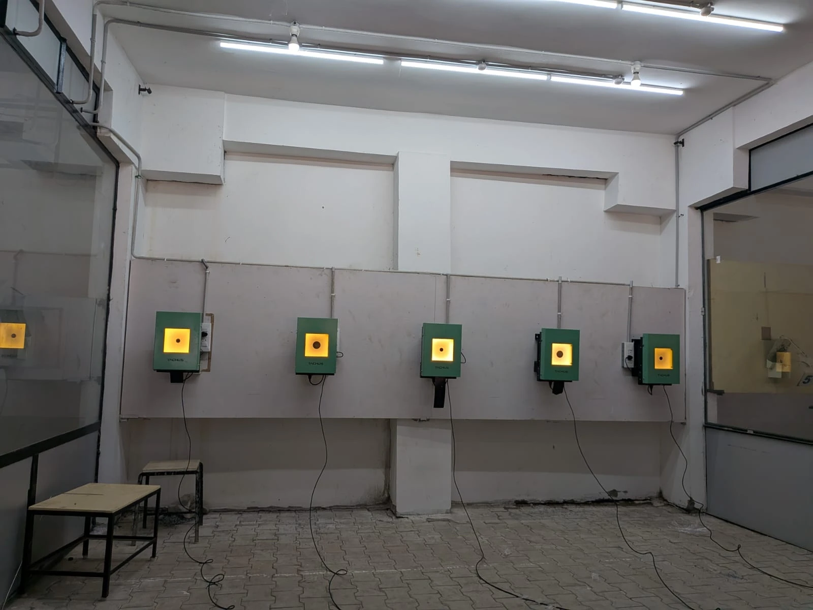 Five Tachus electronic targets illuminated at an indoor range